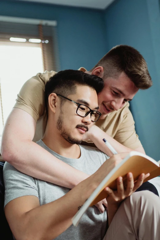 there is a man sitting on the lap with a man looking down