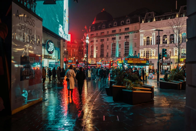 people walking down the street in the rain