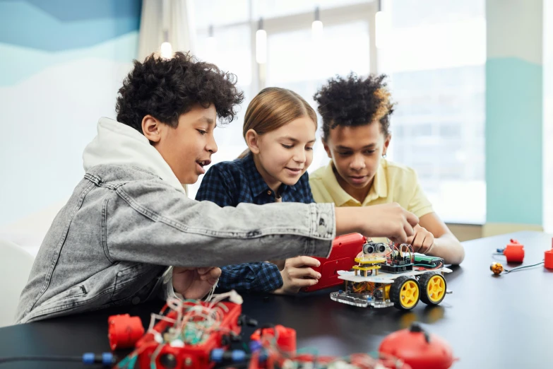 three young s are playing with a toy