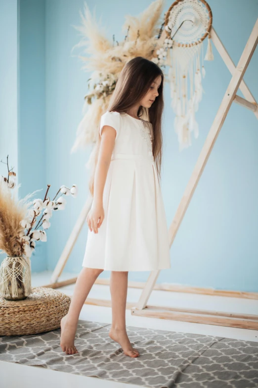 a  wearing a white dress and holding a flower bouquet