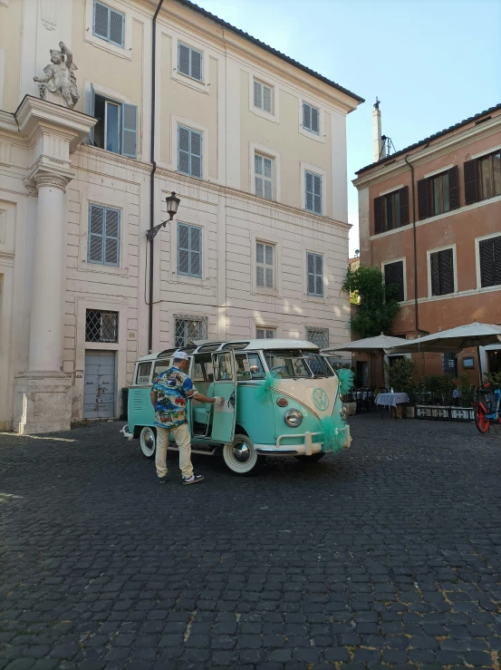 two vans with bicycles on them are parked in front of a building