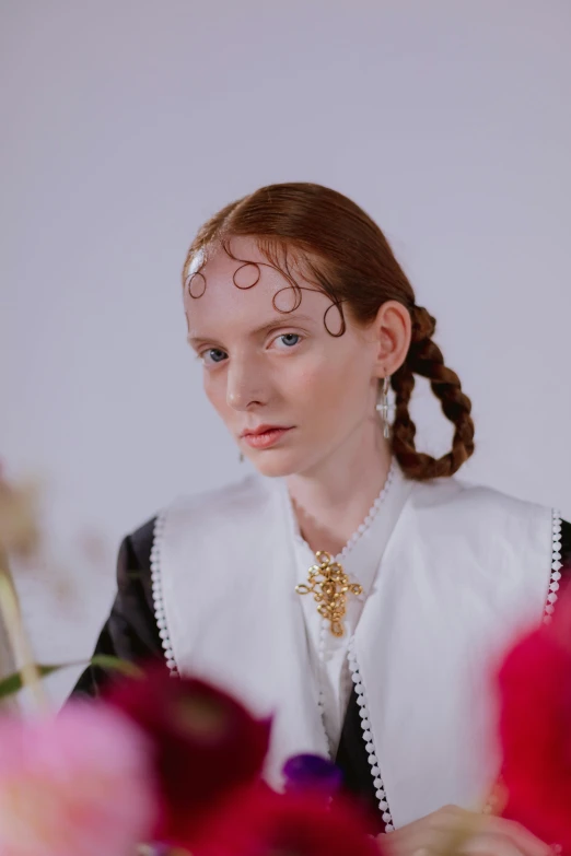 the woman with red hair is dressed in a white shirt and black skirt