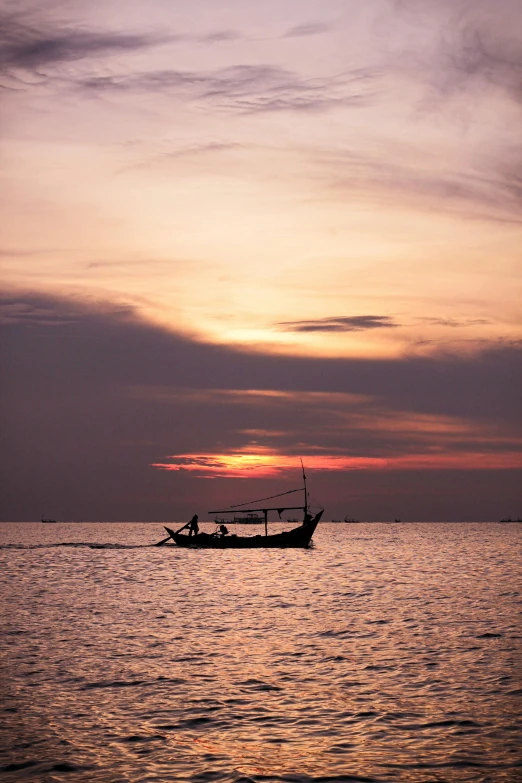 a boat with a man inside it is traveling through the water