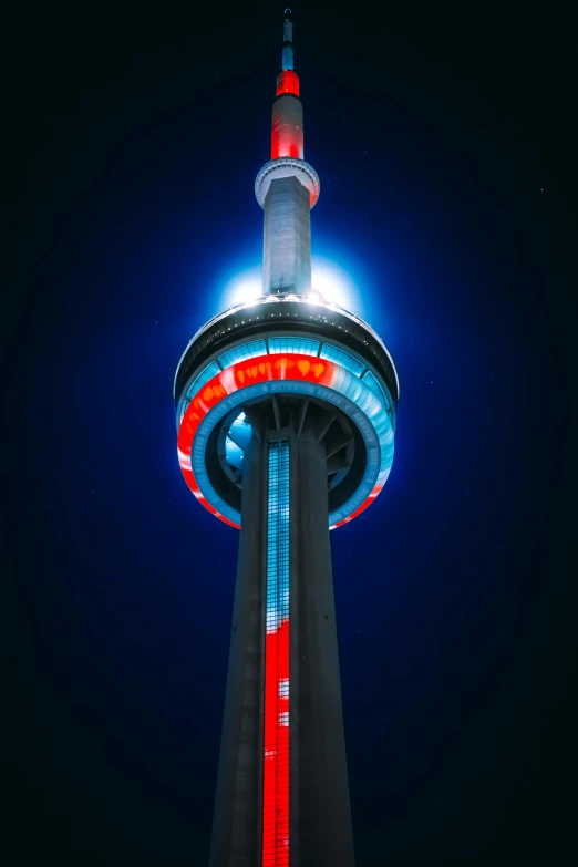 a very tall tower with a red, white and blue top