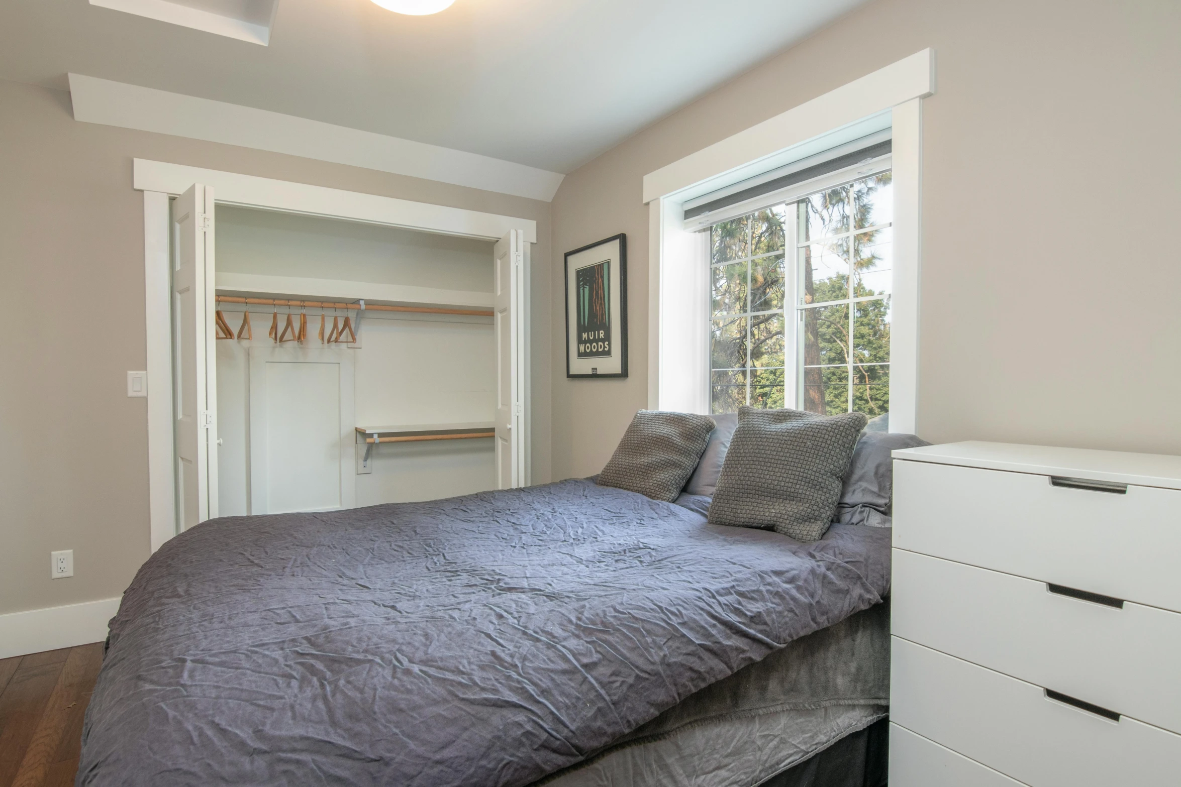 a bedroom with a bed and window inside of it