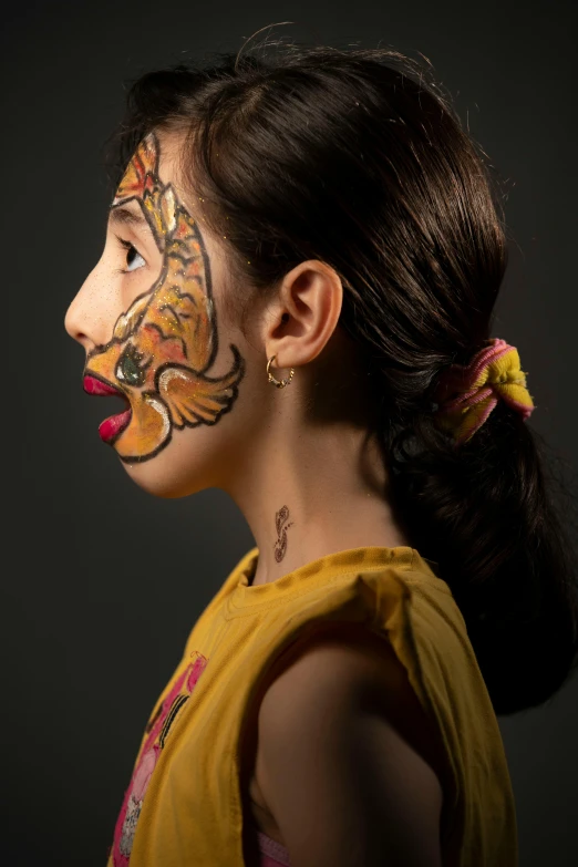 a girl with the face painted in tiger designs