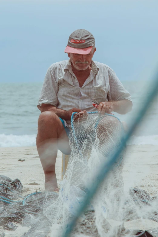 a person wearing a hat and sitting on a chair