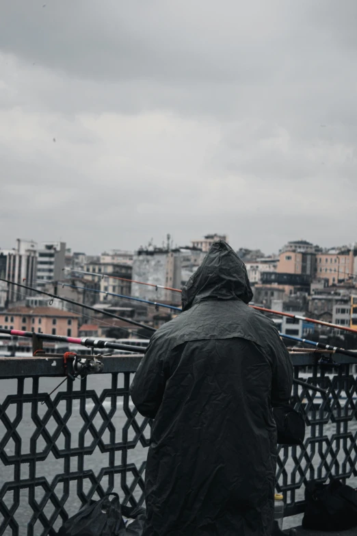 a man is fishing from the top of a bridge