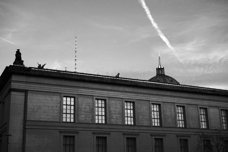 a black and white po of an old building with a sky background