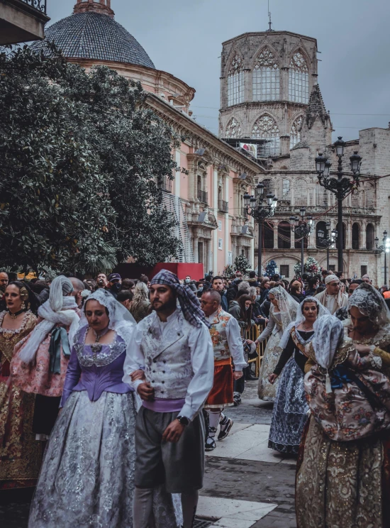 some people standing together by some buildings