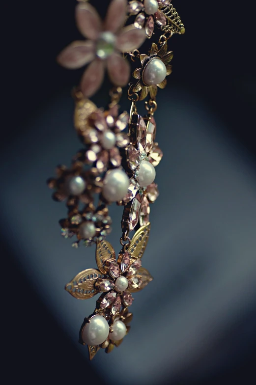 an ornate necklace with pearls on a piece of jewelry