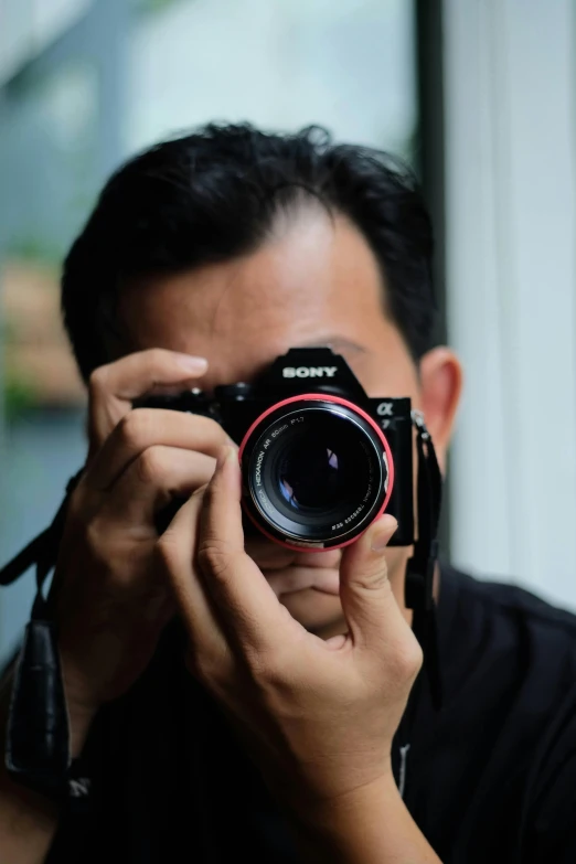 a man holding up his camera and posing for a picture