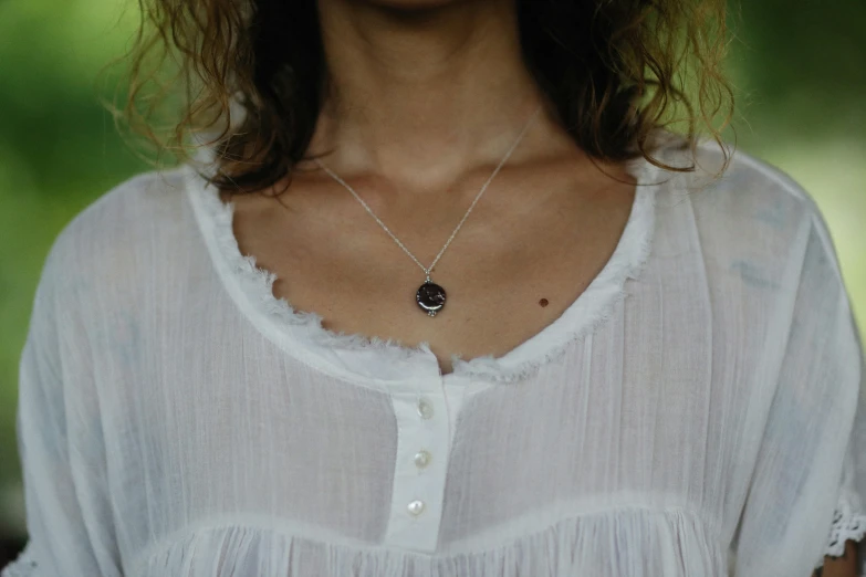 a woman with a necklace on her neck