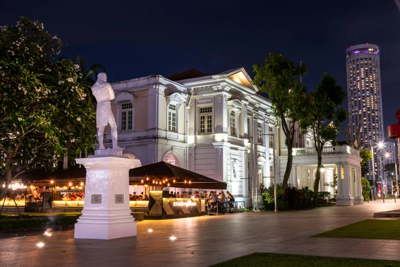 a large building on a city street at night