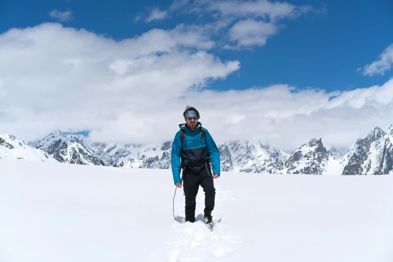 a man standing in the snow while wearing skis