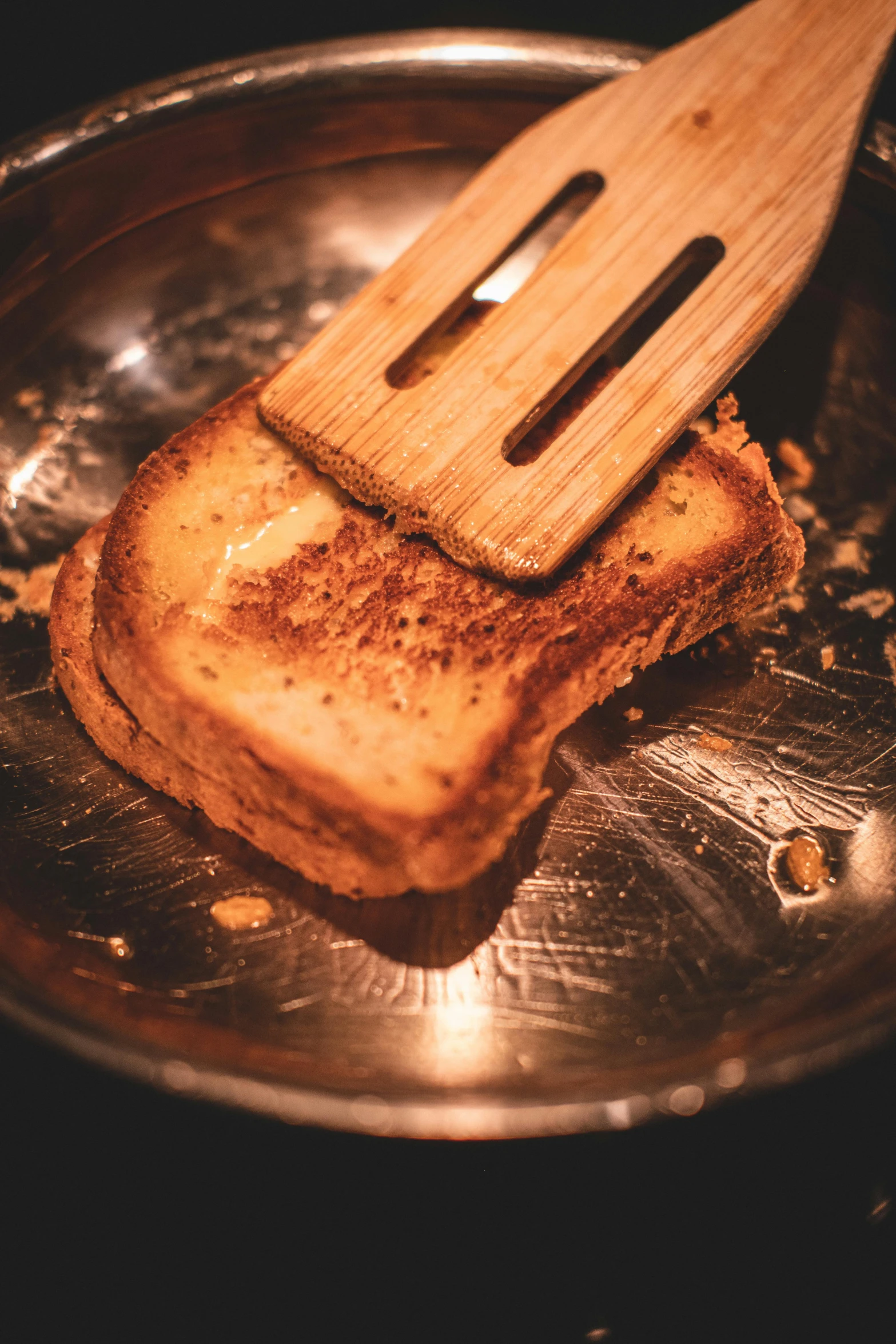 a toast that has been grilled is being held by an electric knife