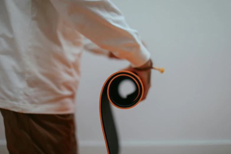 a person holding soing in their hand while wearing white shirt