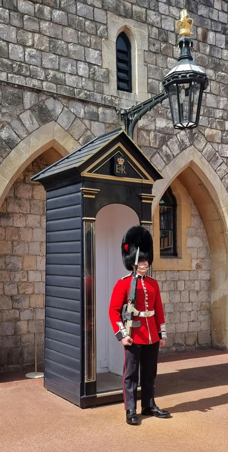 a man dressed in red stands in front of an open doorway