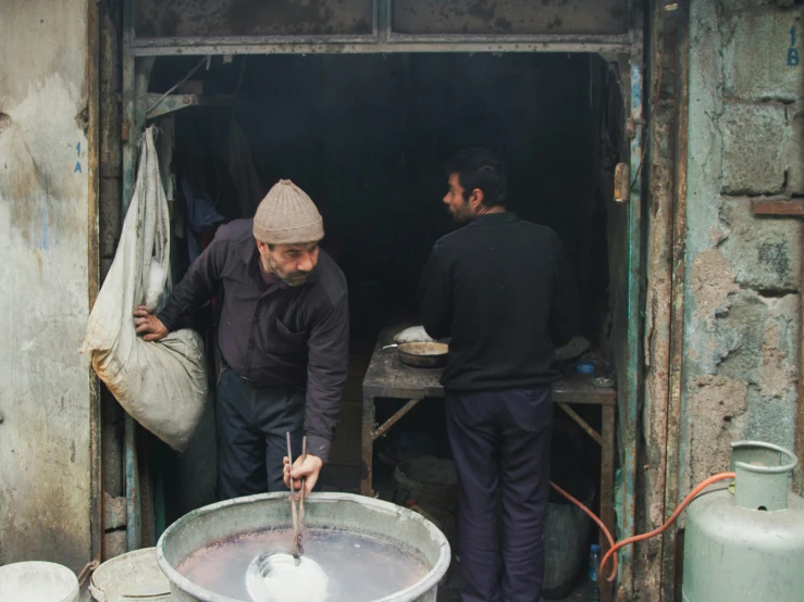 a man making soing at a well in the out door