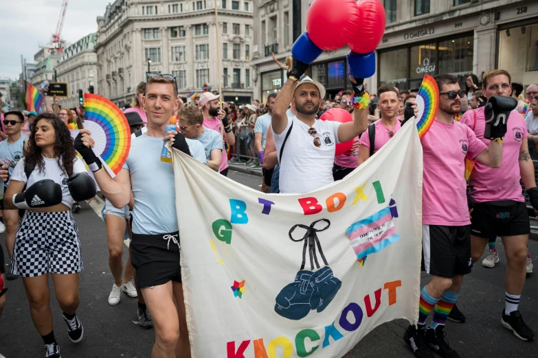 the men are marching in the street carrying their banners