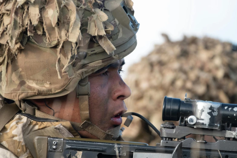 a close up s of a military soldier aiming his scope