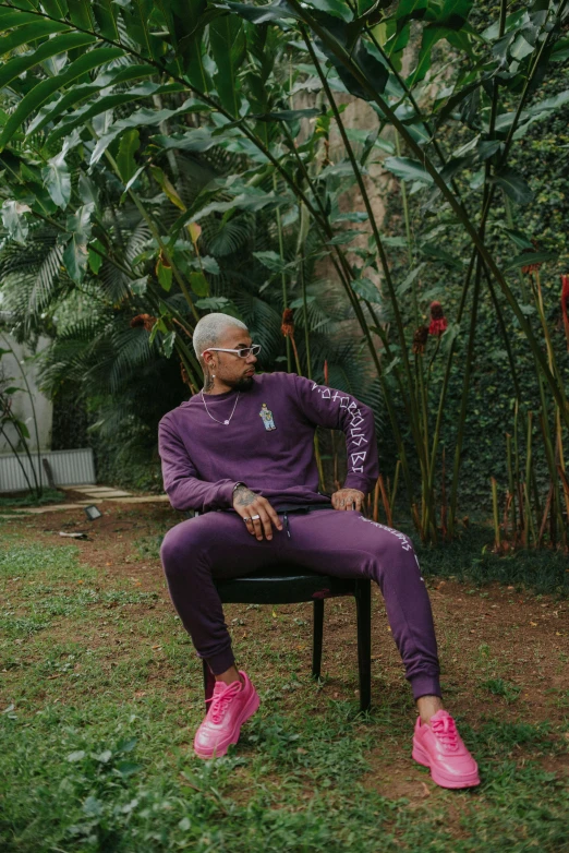 a man sitting in a chair with his feet crossed