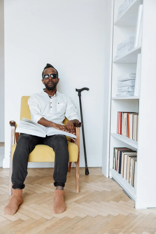 a man sitting on top of a yellow chair