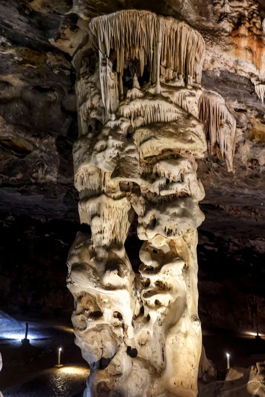 rock formations and caves filled with water under lights