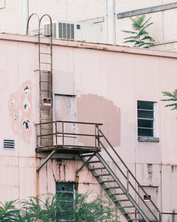 there is a pink building and metal steps