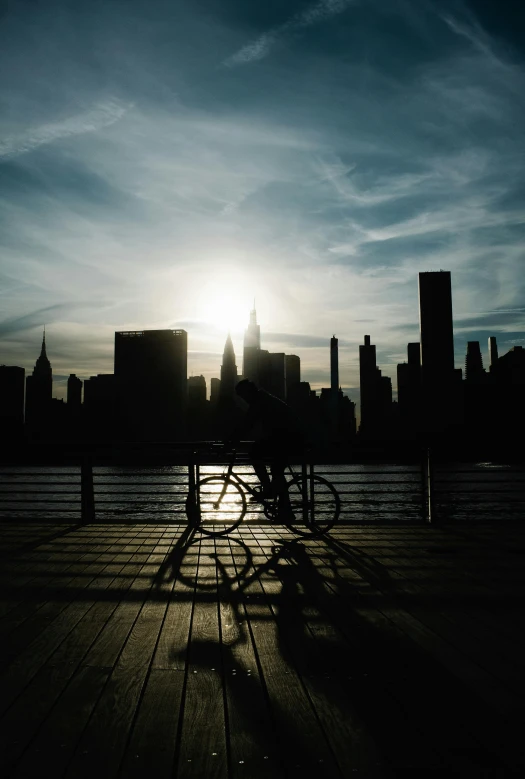 a bench and railing in front of city skyline