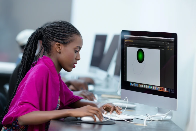 a woman using a computer monitor at her desk