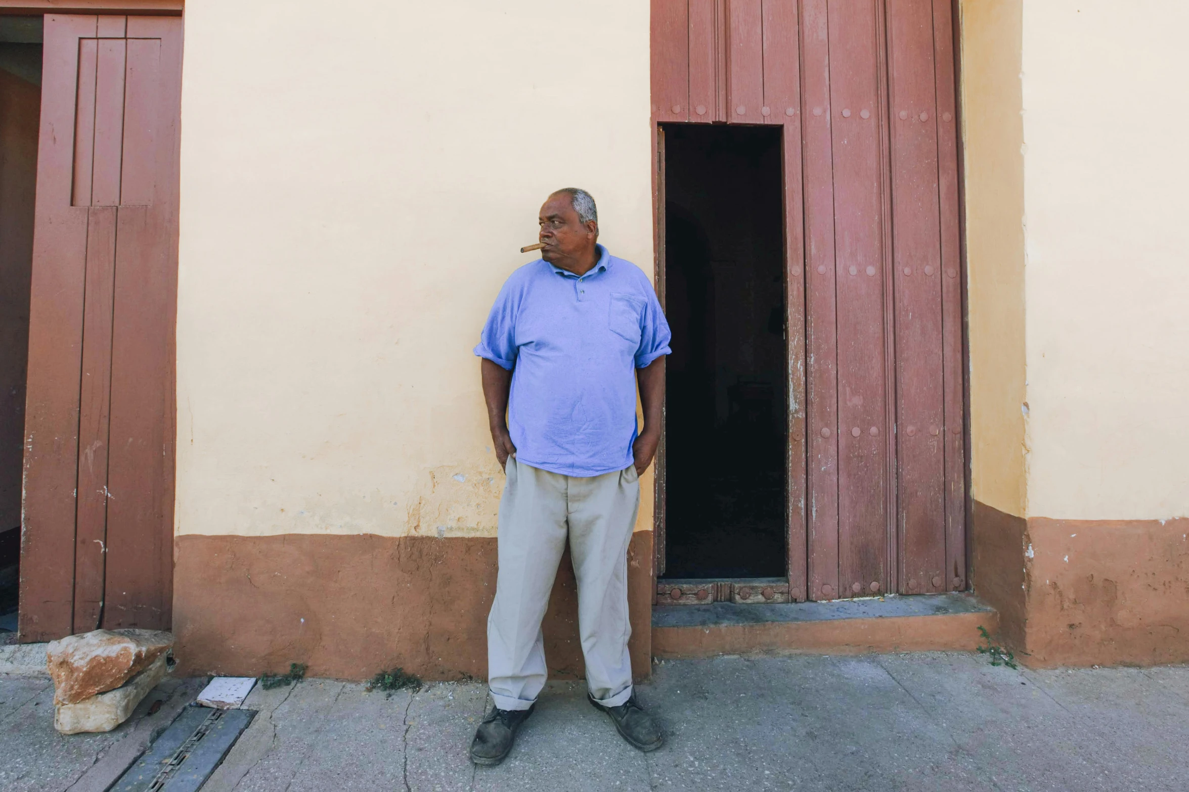 a man in front of a door and two windows