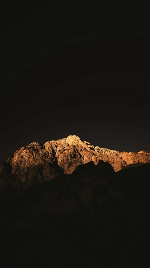 a mountain covered in snow next to the night sky