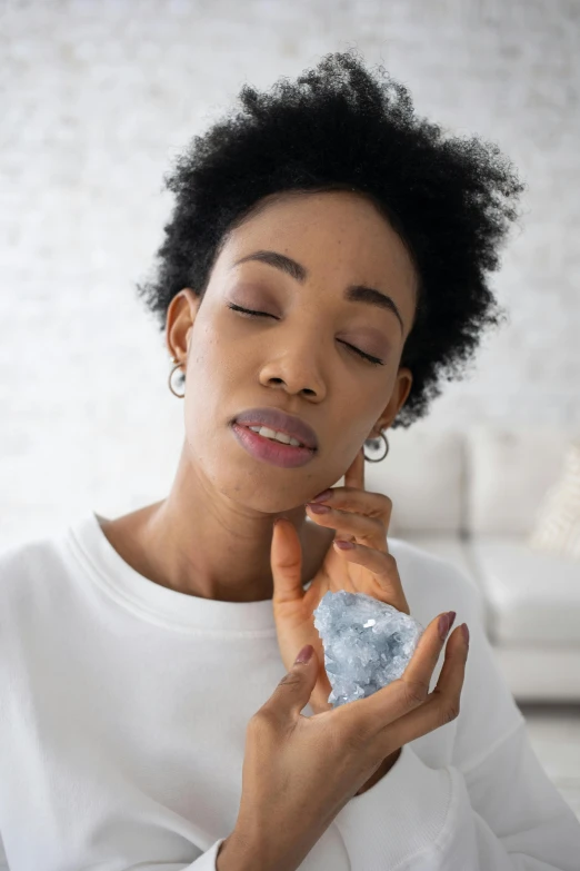 a woman looking at a diamond stone in her hands