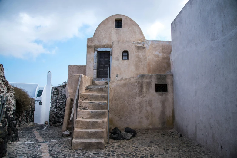 the stairs lead up to the door to a small building