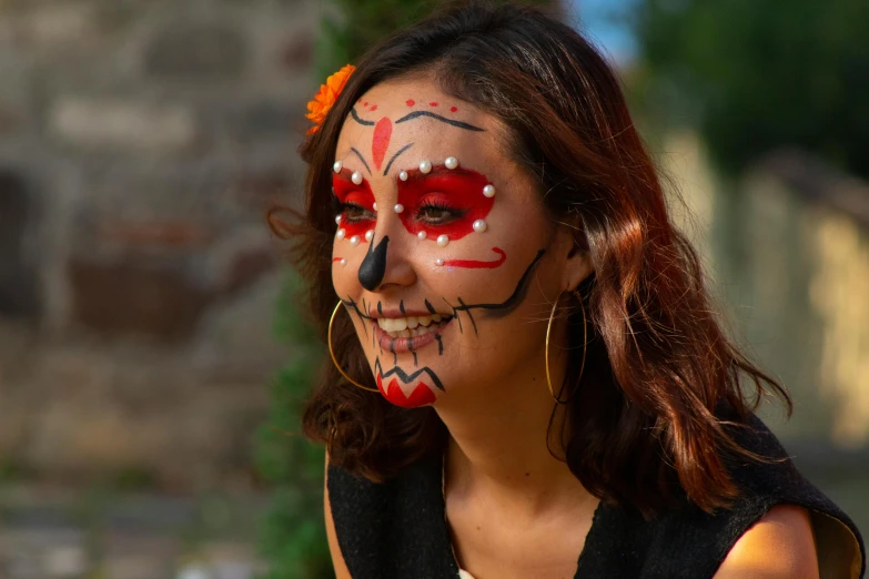 a young woman with colorful makeup and piercings stands outside