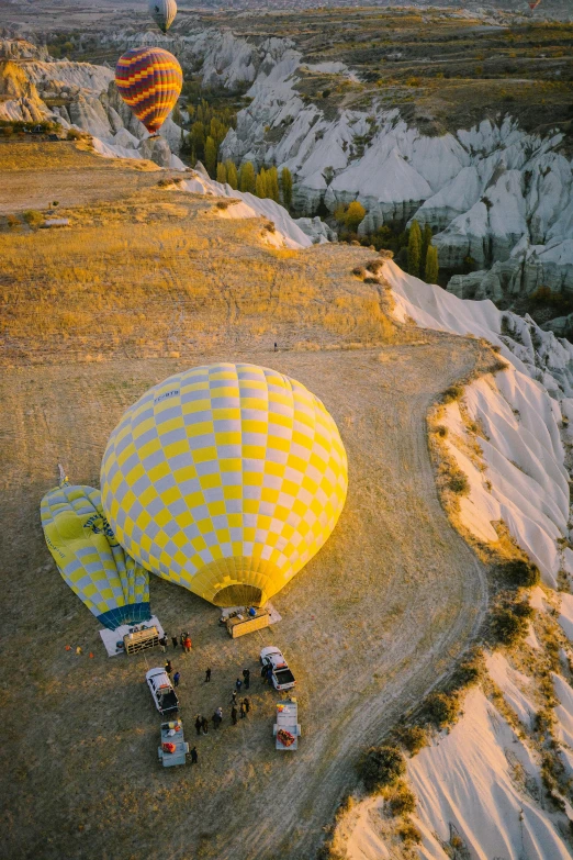 many  air balloons are in the sky above a valley