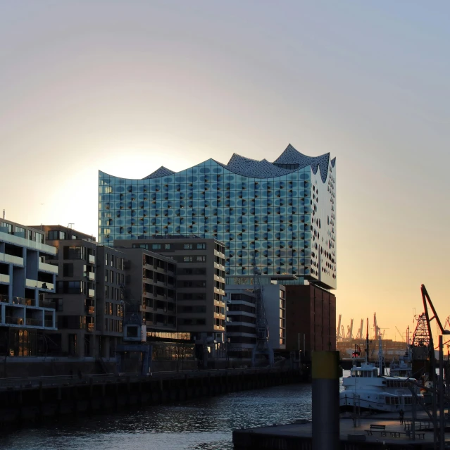 a city skyline showing two buildings that are next to a body of water