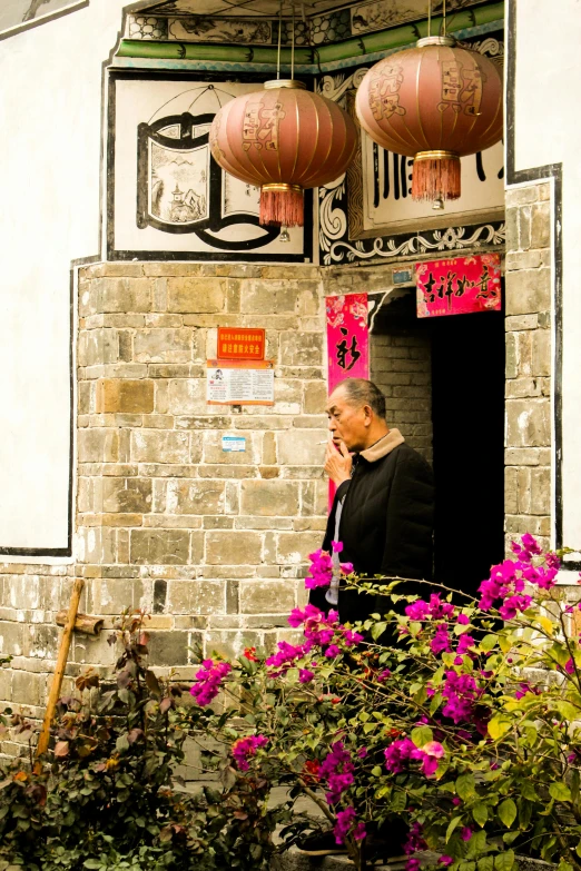 a man on his cell phone outside of a building