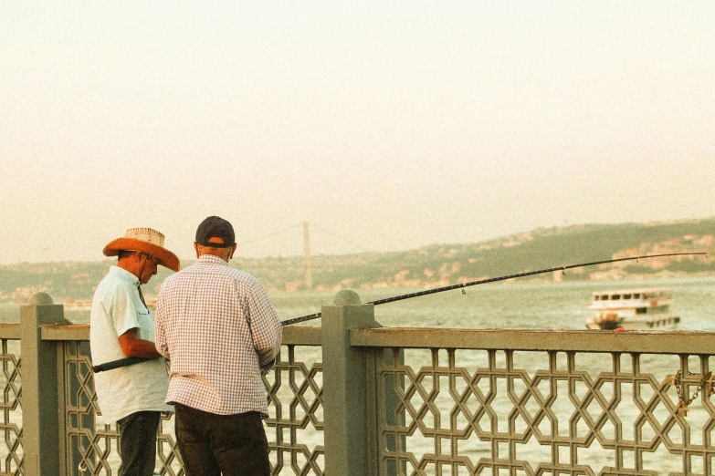 two people standing next to each other on a bridge