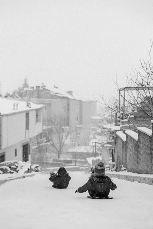 people sit on their snowboards in the middle of a snowstorm