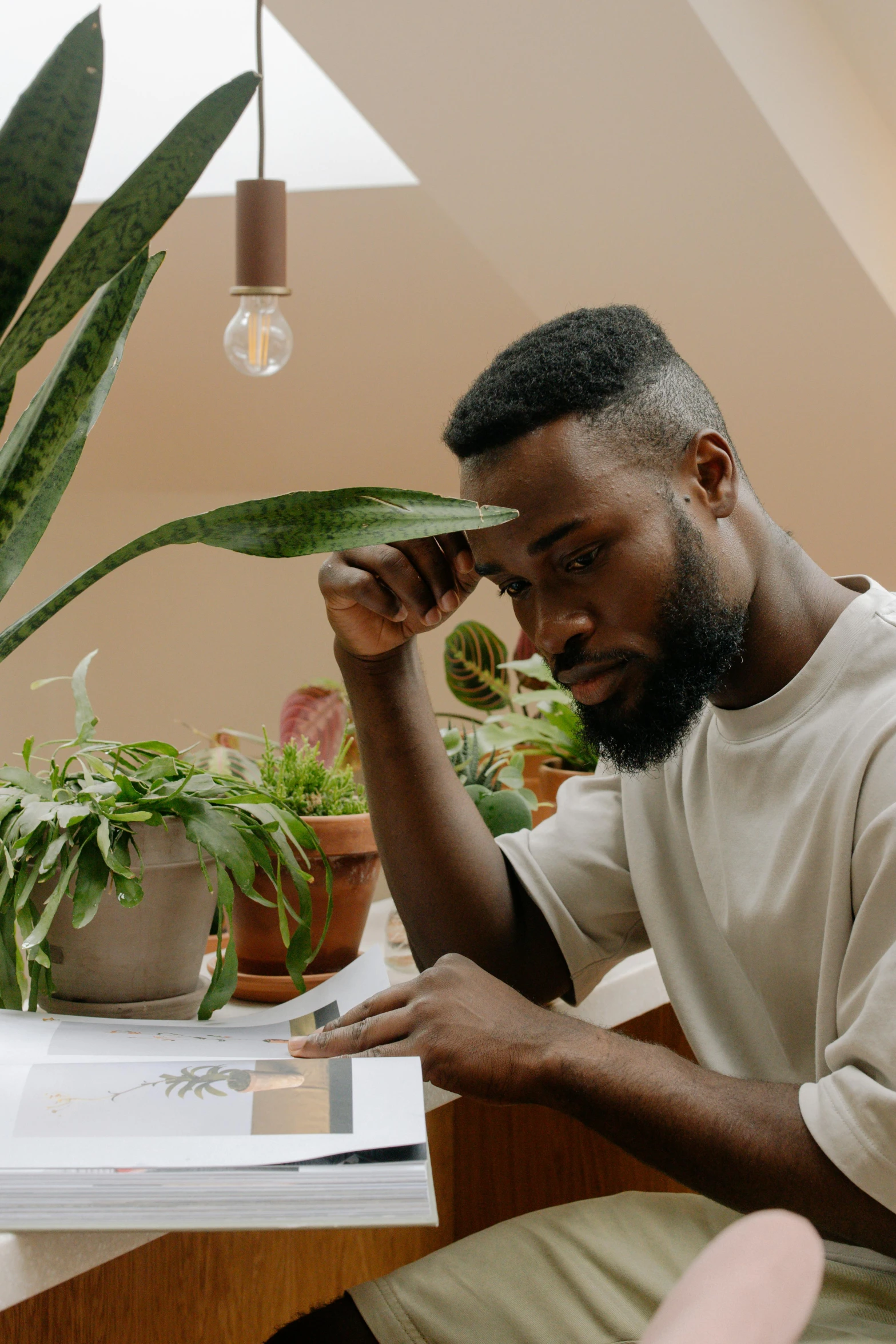 an african american man is reading a book at the desk