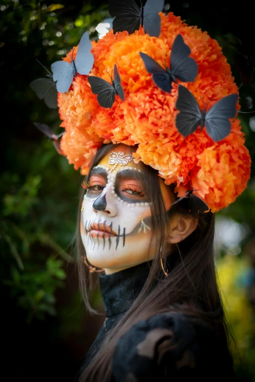 a girl wearing flowers and makeup with erflies on her head