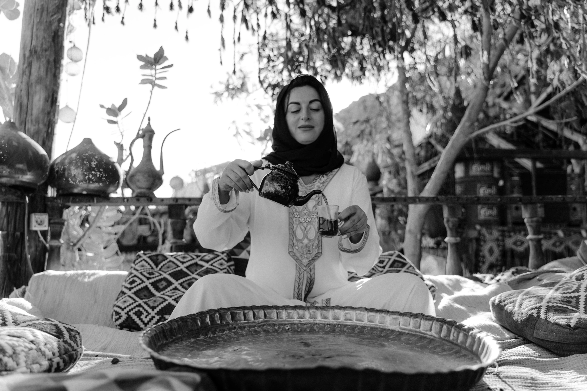 a woman in white dress sitting on top of a floor