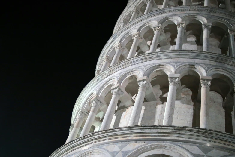 the base of a leaning tower on a dark day