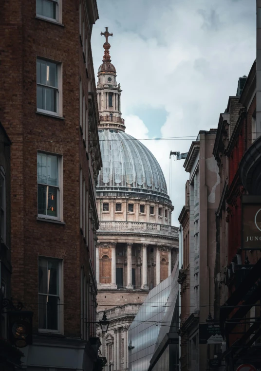 a stone church building behind two tall brick buildings