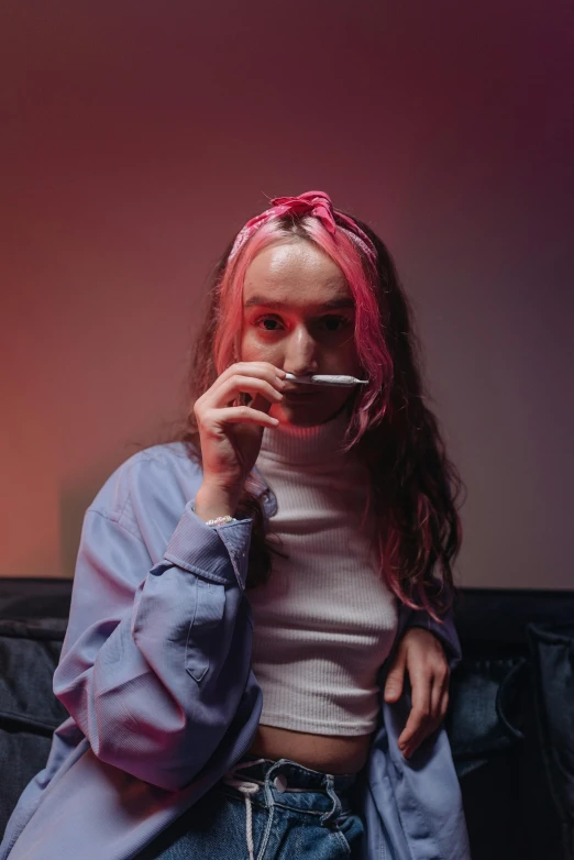 a girl with dyed hair smoking a cigarette