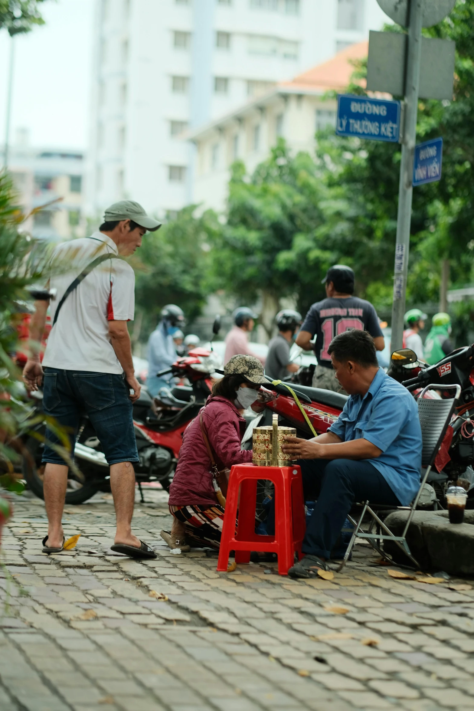 a man sitting on the ground next to other people