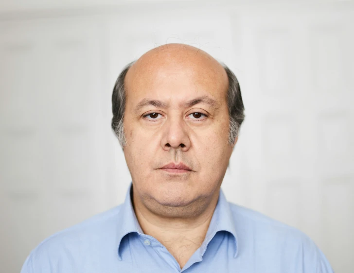 a close up of a man with grey hair and shirt