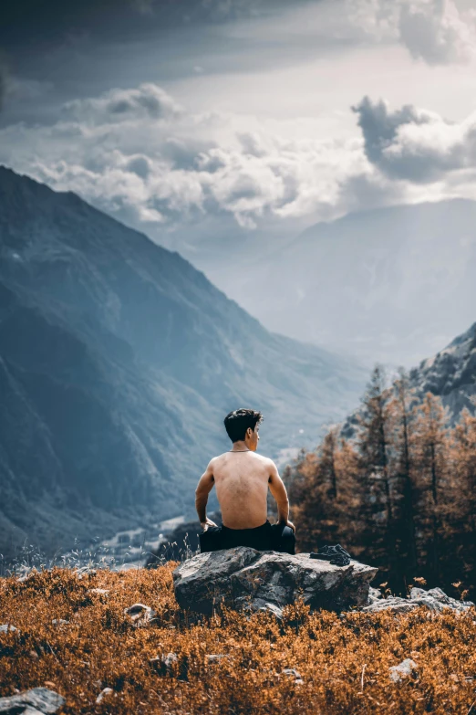 the man in black helmet sitting on the top of the hill